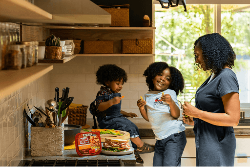 Person checking blood sugar with family support